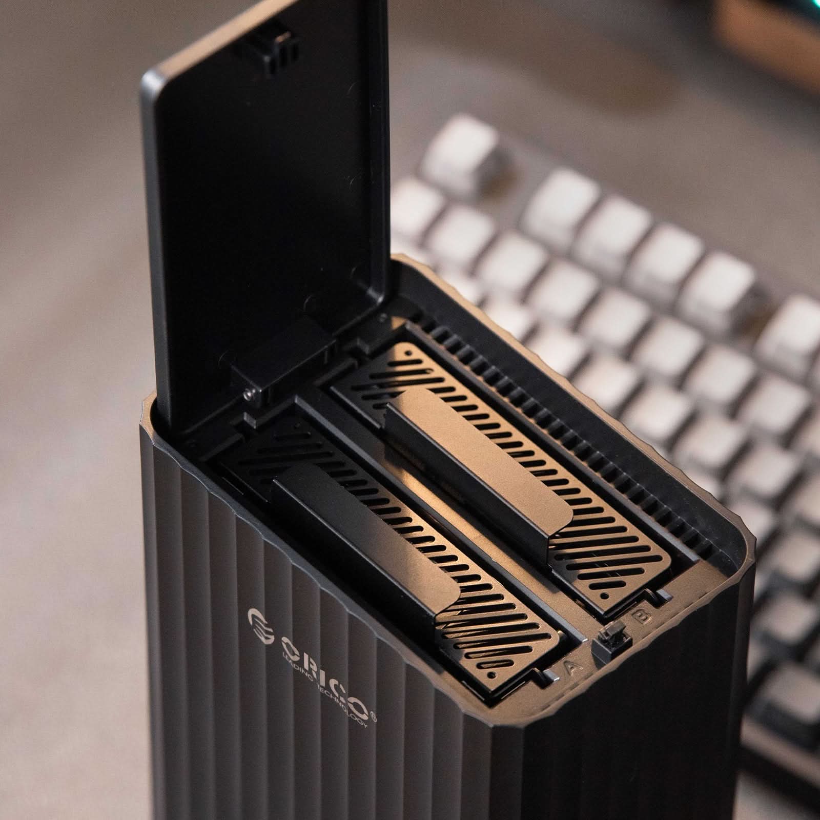 ORICO 5-bay hard drive enclosure with top cover open showing internal SATA drive slots for 3.5 inch and 2.5 inch HDD SSD installation